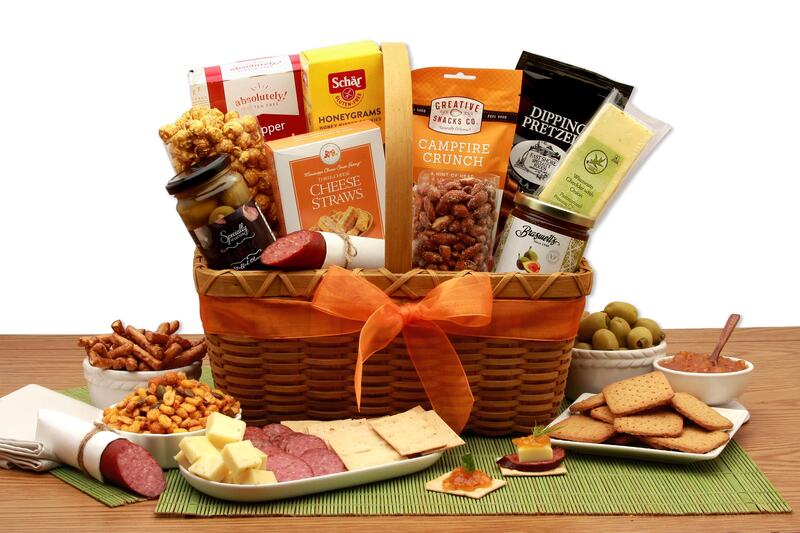 Wicker picnic basket includes a variety of snacking favorites! Includes 
Flatbread crackers,
Honeygrams Crackers,
Butter toffee, caramel corn,
Colossus garlic stuffed olives,
Cheese straws,
Smokehouse almonds,
Dipping pretzels,
Cheddar and onion cheese,
Campfire Crunch snack mix,
Garlic summer sausage, and
Braswells Fig Spread.