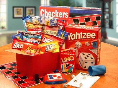 Red gift box is filled with Playing cards,
Checkers, a hand held travel size activity game and a variety of snacks and sweets for family fun!  Large size includes Yahtzee game and more snacks. 