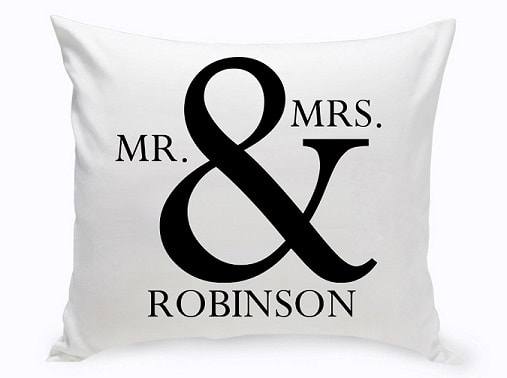 Couples Throw pillow features a bold (and) symbol accompanied by the couple's last name. Standing out in a nice black and white palette.
