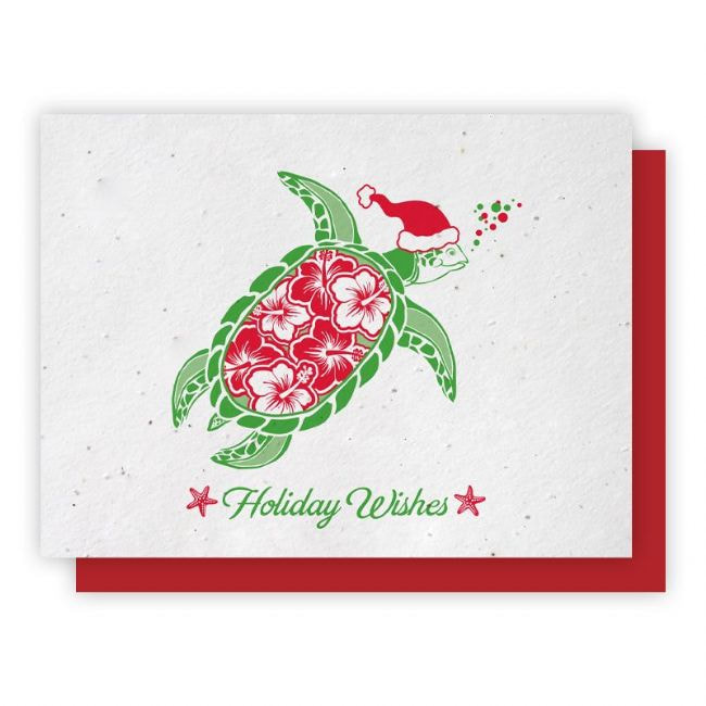 Holiday themed greeting card with embedded wildflower seeds. Green turtle with red Hibiscus print on shell and a red Santa style hat. Select Holiday Greeting Cards category