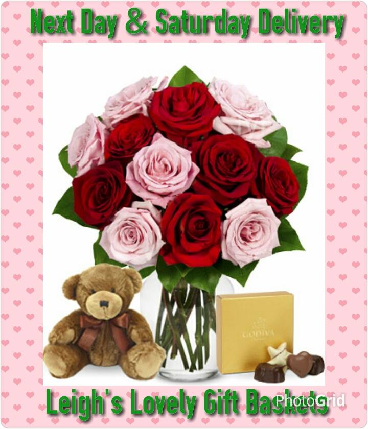 Romancing Rose Bouquet with red and pink roses in a clear glass vase with a miniature teddy bear and box of chocolates