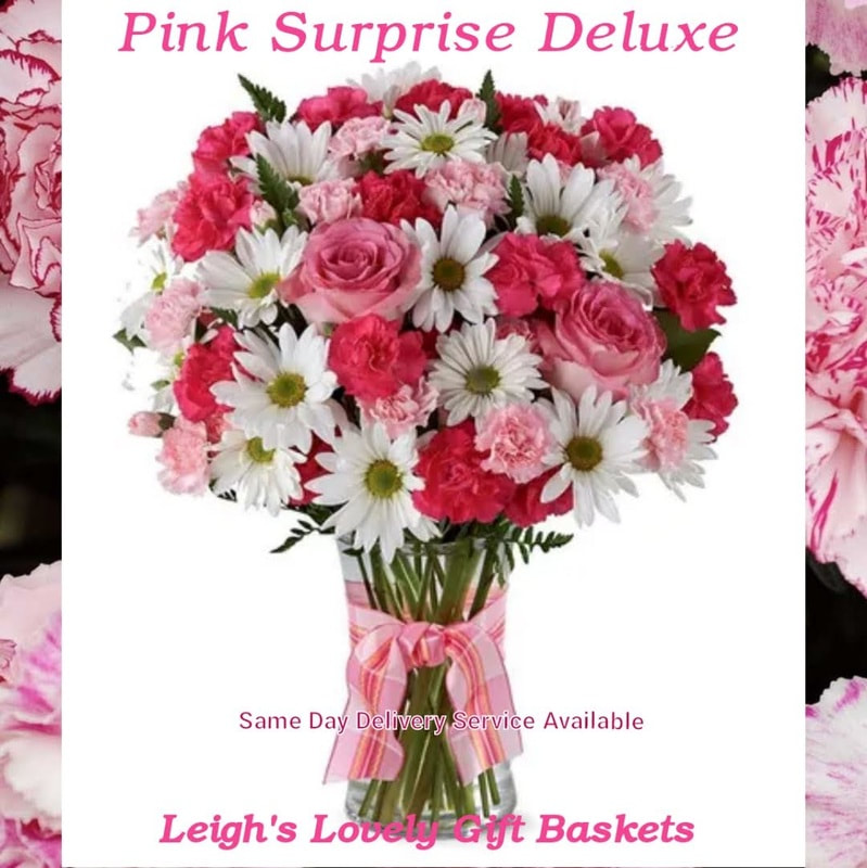 Fresh and delicate, the Pink Surprise Deluxe Bouquet delights with a pallet of light pink hot pink and white flowers arranged in a clear glass vase accented with a ribbon bow.   
Includes ,Hot Pink Spray Roses, White Traditional Daisies and Pink Mini Carnations. Hand arranged and delivered by a local network florist for Same Day Delivery Service Monday through Friday . 
