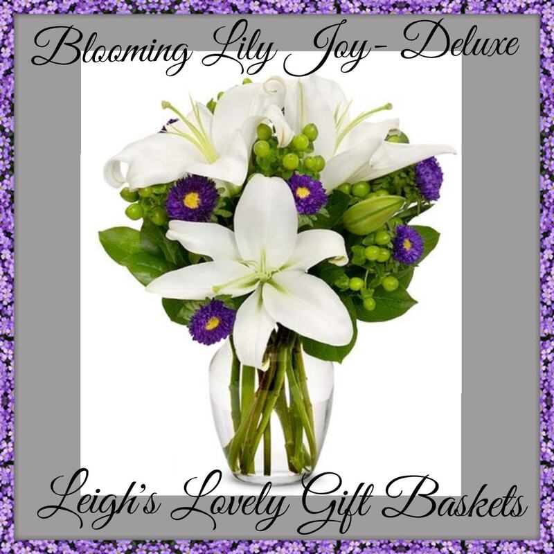 Blooming Lily Joy Deluxe is an elegant and simple bouquet that makes a quiet statement with White Lilies, Green Hypericum Berries and Purple Asters arranged in a clear glass vase. Same Day Delivery Service is available. 