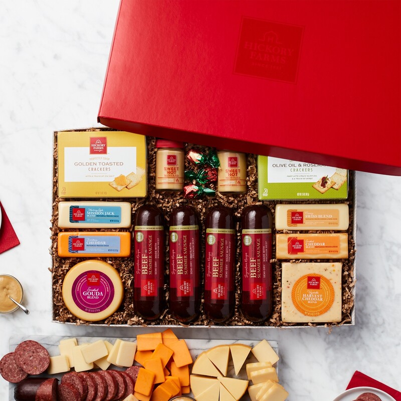Bright red gift box includes Sausage  4 count), Gourmet Cheese 4 count, Spicy Mustard 2 count, Crackers 2 count, Premium Cheese Blends 2 count, and  Strawberry Bon Bons 4 count. 