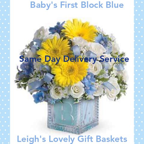 Baby's First Block Bouquet. Blue ceramic block vase with yellow daisies, white spray roses and blue Dephinium