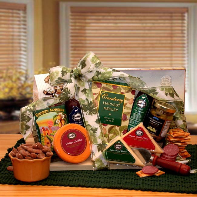 Gourmet Gift Board is overflowing with a delightful array of savory snacks and tied with a classy printed ribbon bow. Includes Parmesan Focaccia crackers, Chocolate chip cookies, Summer salami, Beef sausage, Vintage cheddar cheese round, Swiss cheese triangle, Pepper cheese triangle, Pimento stuffed olives, Smoked almonds, Cranberry medley trail mix, and  Cheese spreader