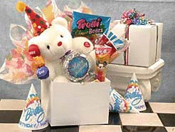 White gloss gift box includes an 8 inch white Birthday Bear with red party hat, birthday hats, balloons,  Silly String,Starlight Mints
Pez Candy Dispenser,Gummy Bears, and Red Vines Licorice.
