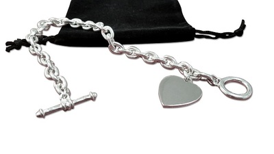 Tiffany Inspired - Toggle Heart Bracelet $109.99  
Stunning Tiffany style 100% Sterling link bracelet with engravable heart that dangles from the end.
Personalize with one Block Initial or Date