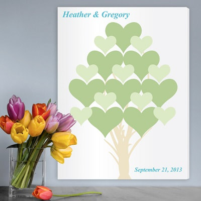 Tree of blooming hearts in shades of green against a white background makes a sharp contrast. Couples first names and event date personalization appear in the corners to allow plenty of room for guest signatures. 