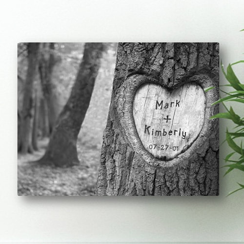 Stretched canvas print features a tree carved with heart and couples names and date. Timeless appeal and special memories. 