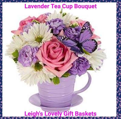 Lavender Tea Cup Bouquet with Pink Roses, Purple Carnations,  White Daisies and
 Seasonal Greens in a lavender tea cup with saucer.  Same Day Delivery Service available