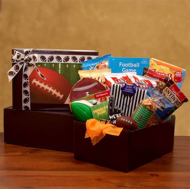  Football themed care package includes a mini finger table top game, Football chip bowl, Referee bottle cover,Relaxable stress football, mini foam football, Football penalty flag, We're number 1 foam finger, referee whistles and a delicious assortment of snacks.  Comes packed in a brown gift box as a care package with a football graphic