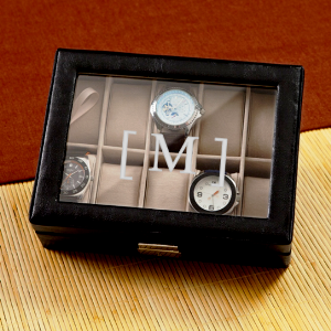 Men's Watch Box $58.99  Black top-stitched leather watch case with glass hinged lid,10 khaki suede-like removable velvet cushions and a polished nickle clasp closure
Personalize with one initial .
