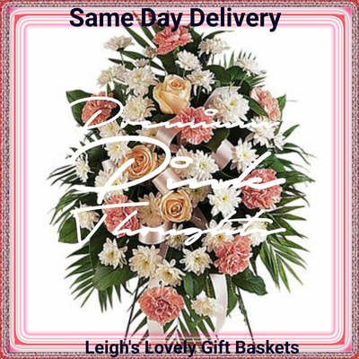 Premium Pink Thoughts Standing Spray features Pink Carnations,White Spray Chrysanthemums and Seasonal Roses trimmed with pink ribbon bow. Includes a customizable Sympathy Banner up to 25 characters and Stand. Same Day Delivery Service available. 