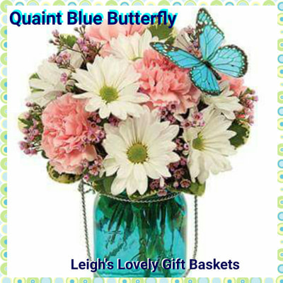 Quaint Blue Butterfly Bouquet is soft and serene with White Daisies,Pink Carnations, Pink Waxflower and Pittosporum in a
 Blue Mason Jar and topped with a Butterfly Pick.  Same Day Delivery Service available Monday- Friday. Order before 10 am EST. 
 