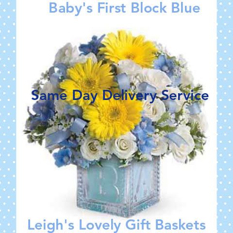 Send your welcome wishes to the new baby's family with this gorgeous floral arrangement nestled into a blue block vase. An artful arrangement of Yellow  Daisies, White Spray Roses and Blue Delphinium is accented with a decorative blue bow. Same Day Delivery Service is available by a network florist. 