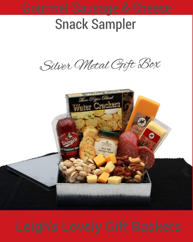 Classic silver metal gift box with lid holds a variety of delicious savory snacks. Includes Usinger's Beef summer sausage, Maine Maple Champagne mustard, Mozzerella cheese bar, smokey Wisconsin cheddar bar, pistachios, mixed nuts, Three Pepper water crackers.  Natural 13 x 13 inch pine box tray Includes Spicy peppered Bavarian meat wheel, Usinger’s Thueringer Sausage, Italian Style sausage, Beef Salami with Garlic, Summer Sausage,  Bavaria Hot Spicy smoked sausage Wheel, Horseradish Mustard, Blue Cheese Herb Mustard, Horseradish Cheese Square,  Roasted Garlic Cheese Square, Chipotle Cheese Triangle, Cranberry Cheddar Cheese Triangle, Jalapeno Cheese Triangle,  Tomato Basil Cheese Triangle, Jumbo Cashews,  Smokehaus Almonds, wood handle spreader and cutter. 
Click here to connect to Leigh's online gift boutique.  Click here to connect to Leigh's online gift boutique. Select Gift Baskets from the Shop Menu
Select Meat, Cheese & Nuts Gift Ideas category. 