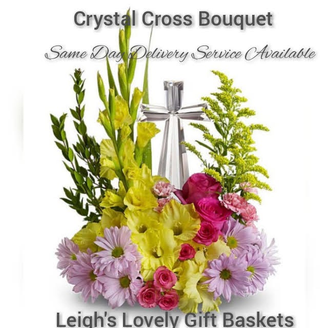 Beautiful Sympathy floral arrangement 
 with Pink Roses,
Yellow Gladioli,
Purple Daisies,
 Pink Carnations, 
Chrysanthemums, Solidago and assorted greenery  with a multifaceted
 Crystal Cross. Same Day Delivery Service available. 