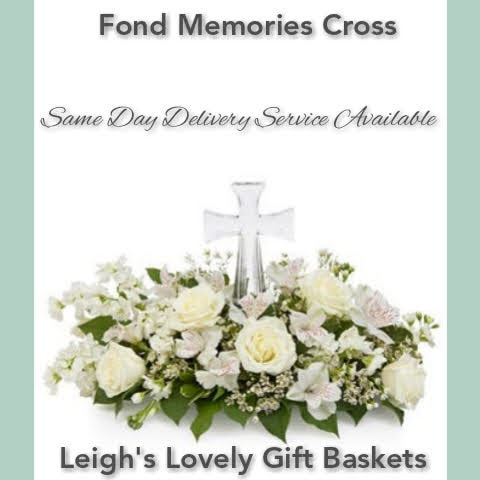 Beautiful Sympathy Floral arrangement in the shape of a wreath with all white flowers and assorted greens.  Includes White Roses, Alstroemeria and Waxflower
and a crystal cross in the center. 