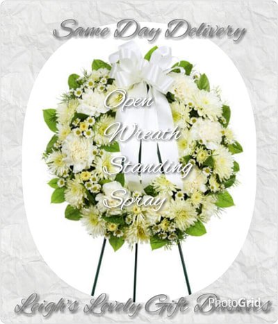 Open Wreath Standing Spray with White Roses,White Carnations,Cushion Poms and Monte Casino on a wire easle and trimmed with a white ribbon bow. Same Day Delivery Service available. 