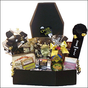 A humorous coffin themed gift box with an Over The Hill Ribbon,  Old Timers Snack Mix, Sugar Free Brownie Bites, 
 Cookies, 
Vanilla Caramels 
Toffee Candy,
 Cheese Buds, and  Over The Hill Coffee Pack